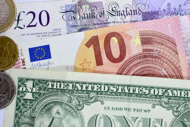 An image of euros, British pounds, and US dollars